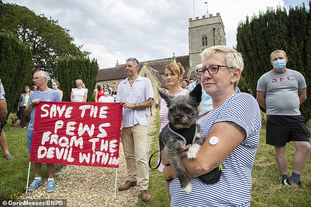 Parishioners, including Dolly the dog, gathered to protest in the grounds at St Andrew