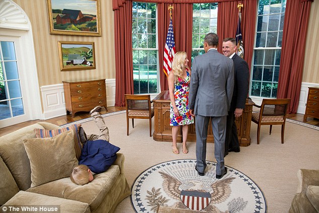 Nosedive: This unnamed child of a Secret Service agent took a leap at an Oval Office sofa behind the President