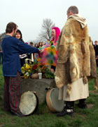 Druids in ritual costume watch as a couple joins hands across an altar
